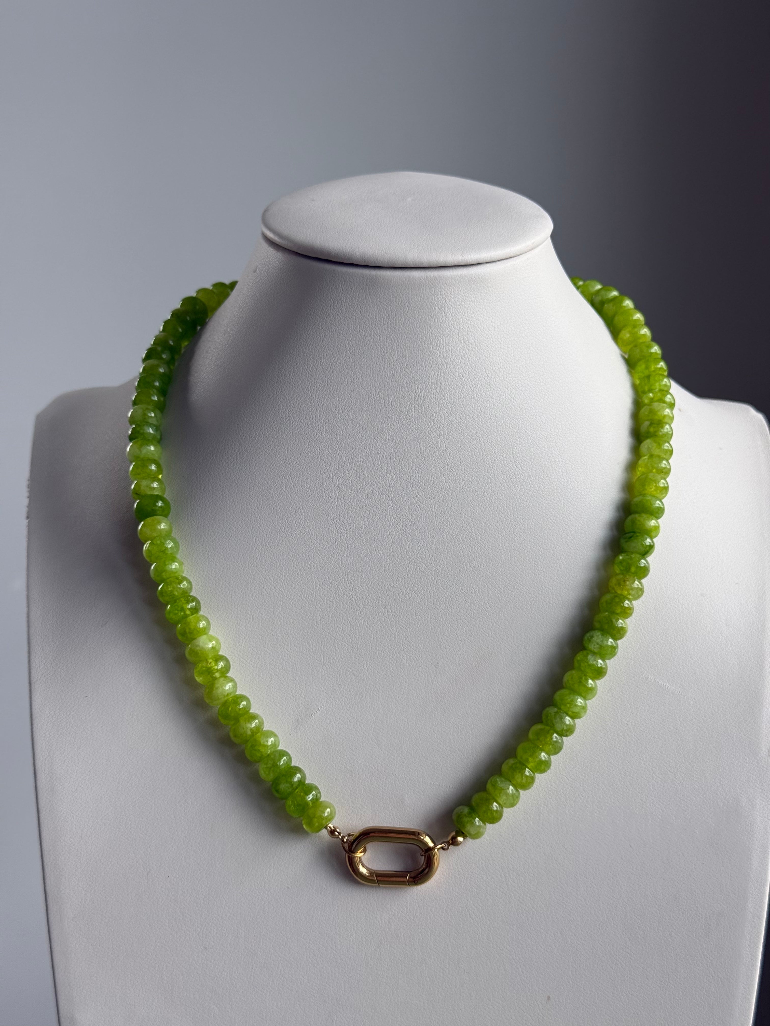 Keepsake Strand Necklace Olive Grove with olive-green beads and a gold-tone clasp on a white bust.
