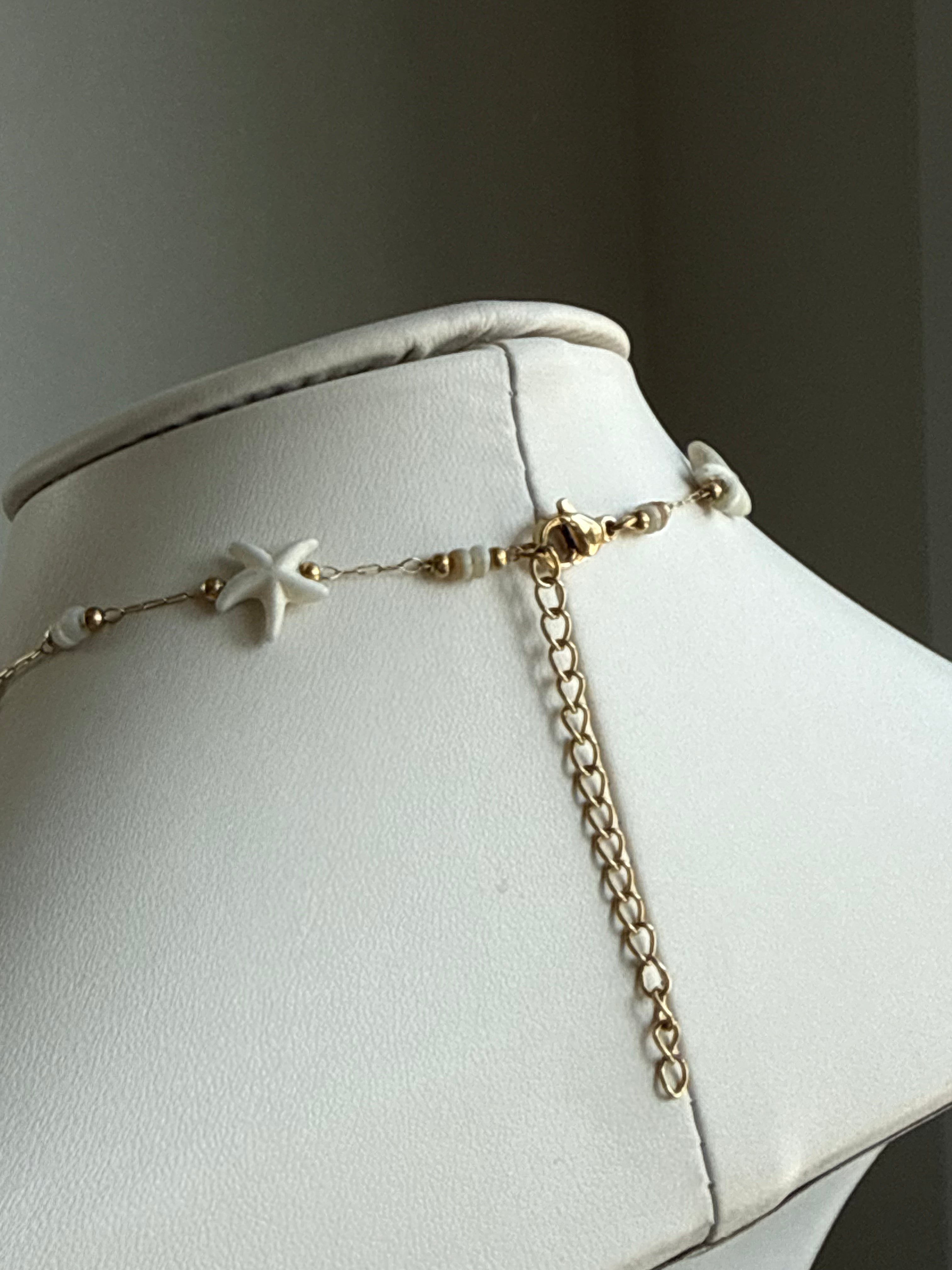 Signature Chain Starfall necklace by From Juniper With Love; gold-tone chain with white star-shaped beads