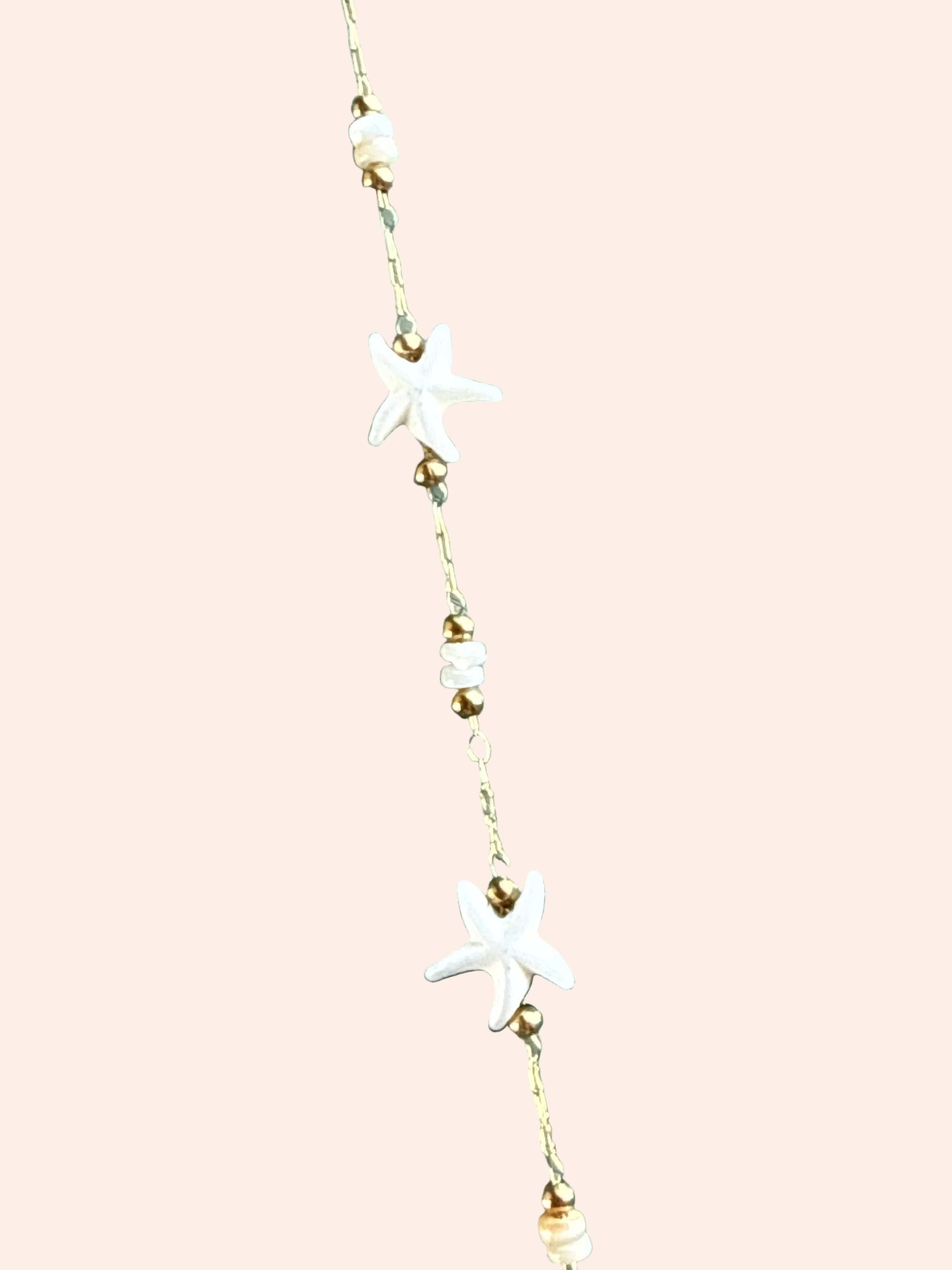 Signature Chain Starfall necklace by From Juniper With Love; white star charms on a gold-tone chain