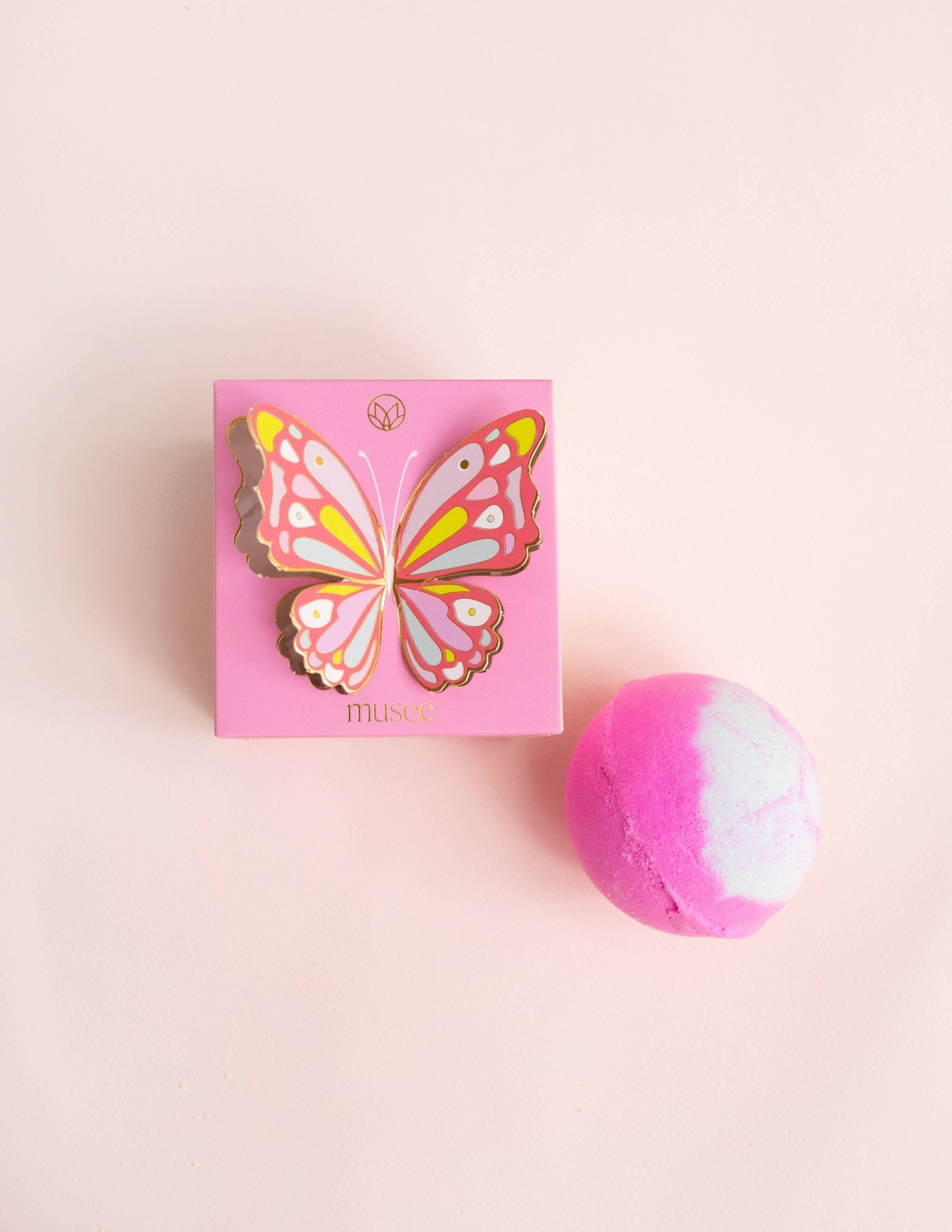 Butterfly Bath Balm by Musee; pink box with a colorful butterfly illustration and two pink marble bath bombs.