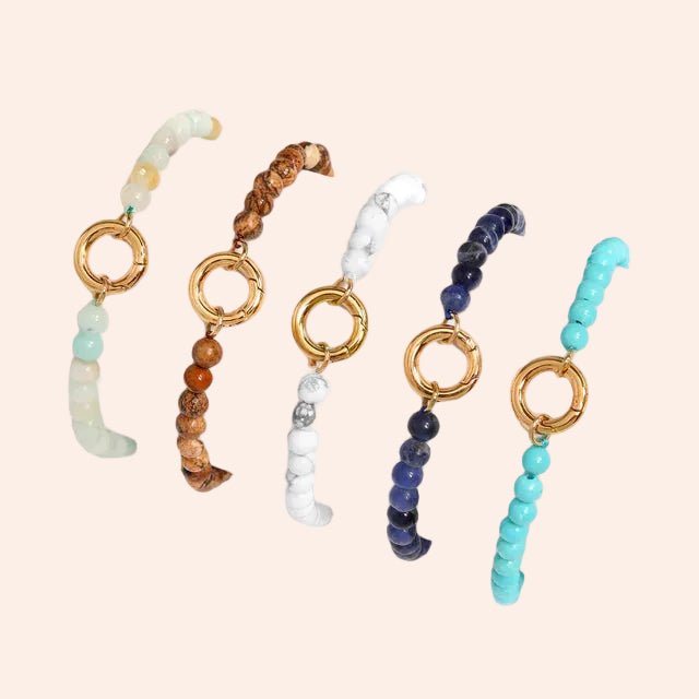 Charm Holder Bracelet: 5 beaded bracelets with gold rings in mint, brown wood, white marble, navy and turquoise.