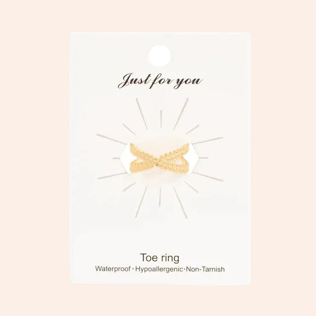 Cross Over Toe Ring in gold tone, shown on white packaging card
