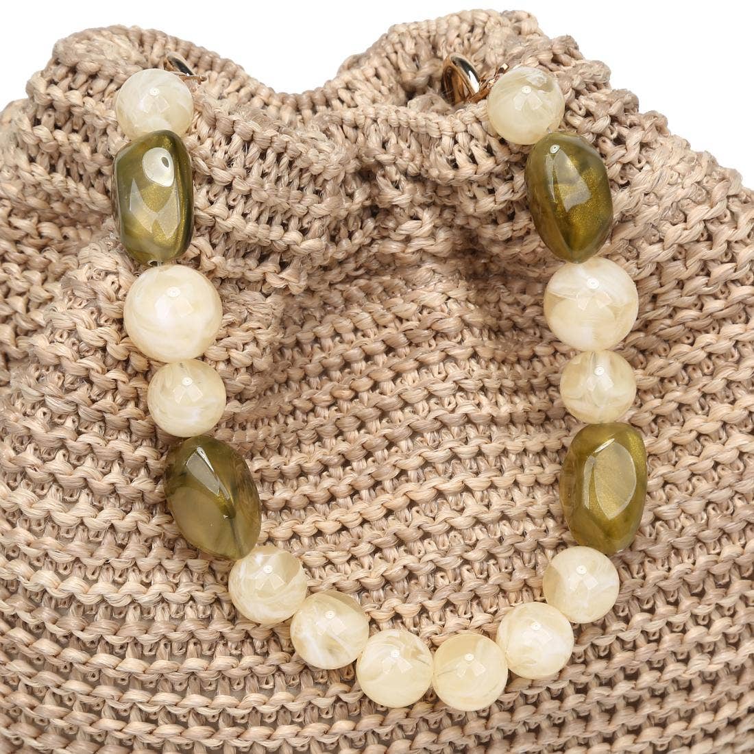 Emery Crossbody bag in natural straw with beaded olive and cream handle by Urban Expressions