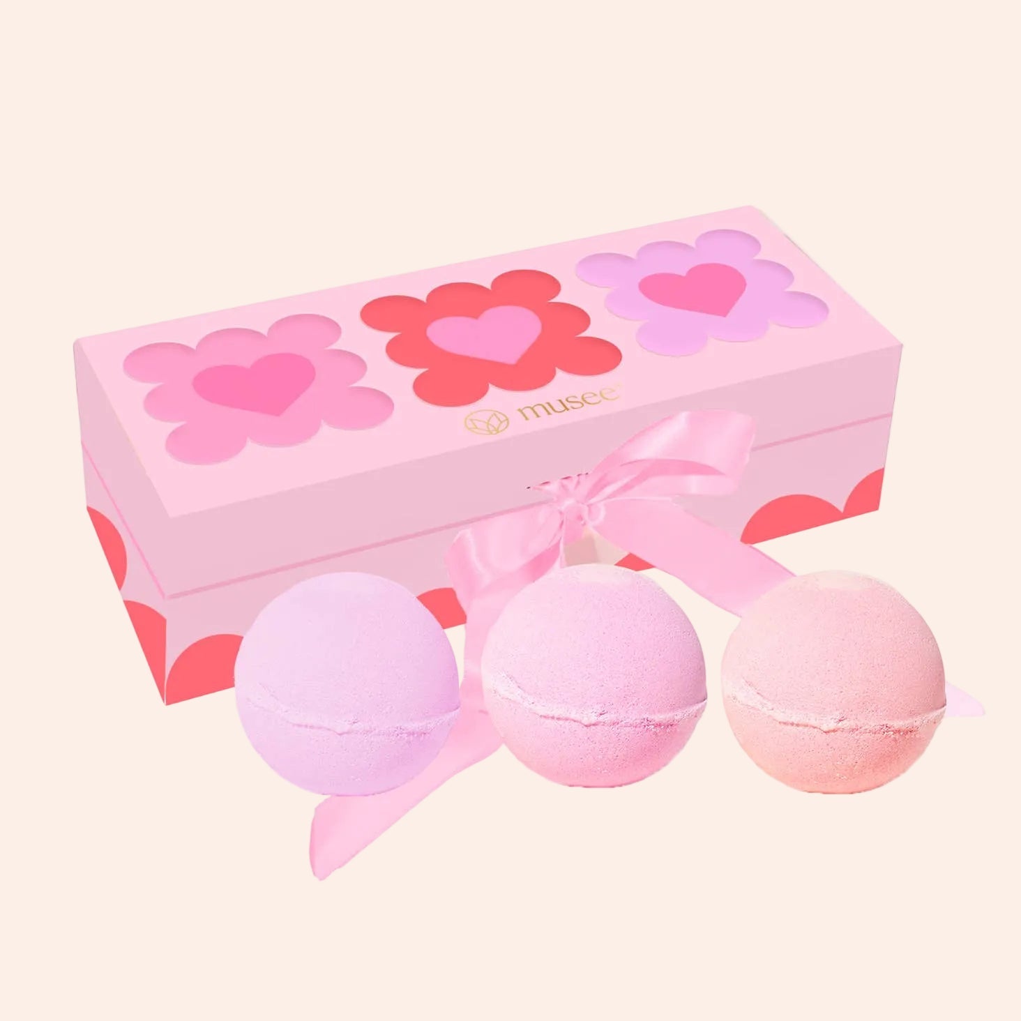 Hearts Three Bath Balm Set by Musee; pink heart-themed box with satin ribbon and three pastel balms in lavender, pink, and peach.