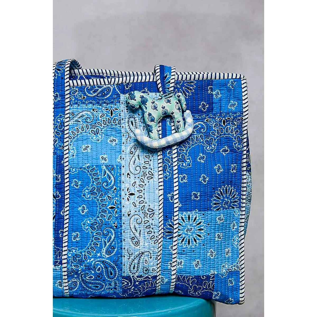 Plush rocking horse bag charm in blue patchwork quilt, POL brand.