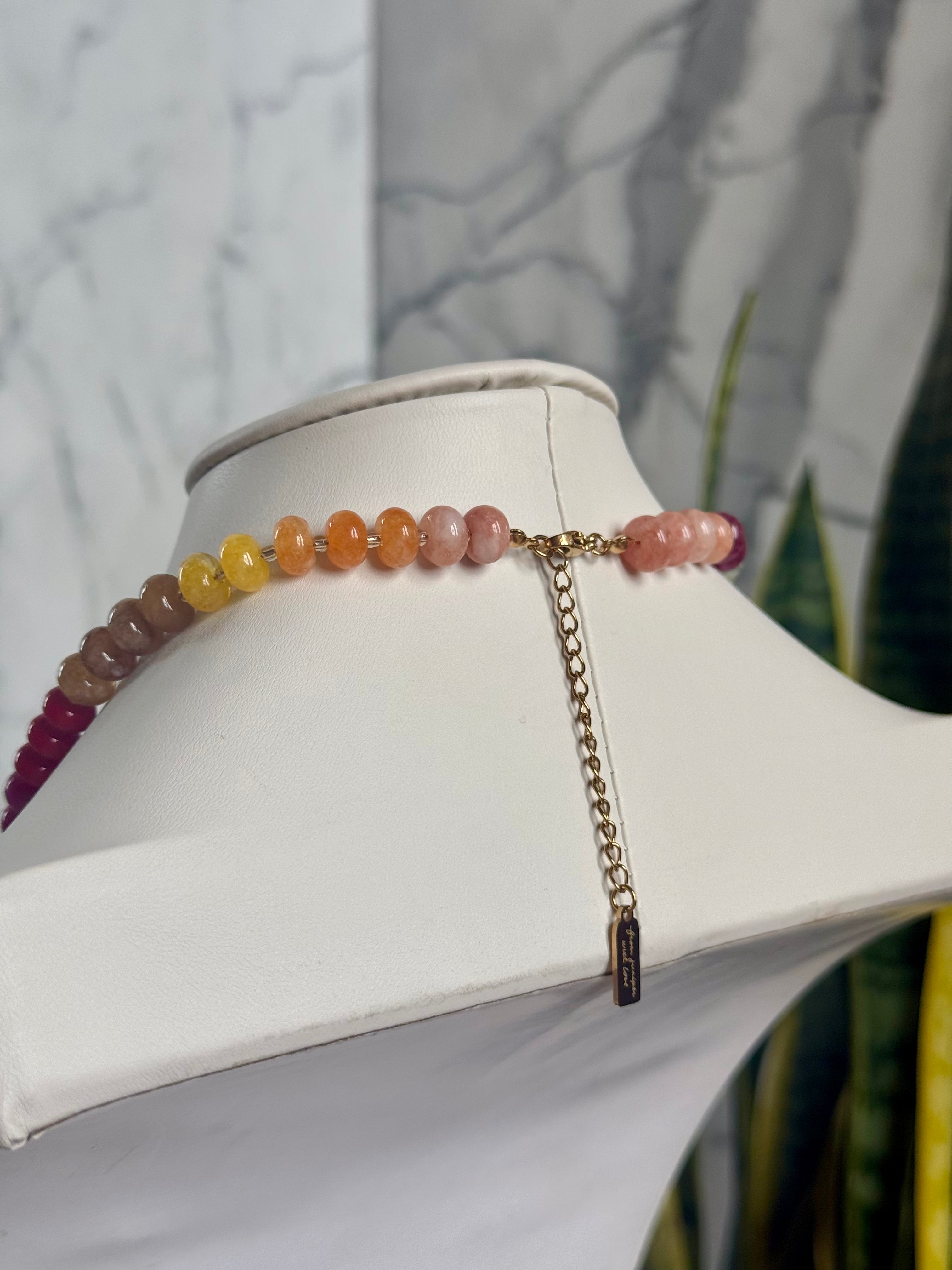 Keepsake Strand Necklace Cooper, pastel gradient gemstone beads in yellow, orange, and pink on a gold-tone chain.
