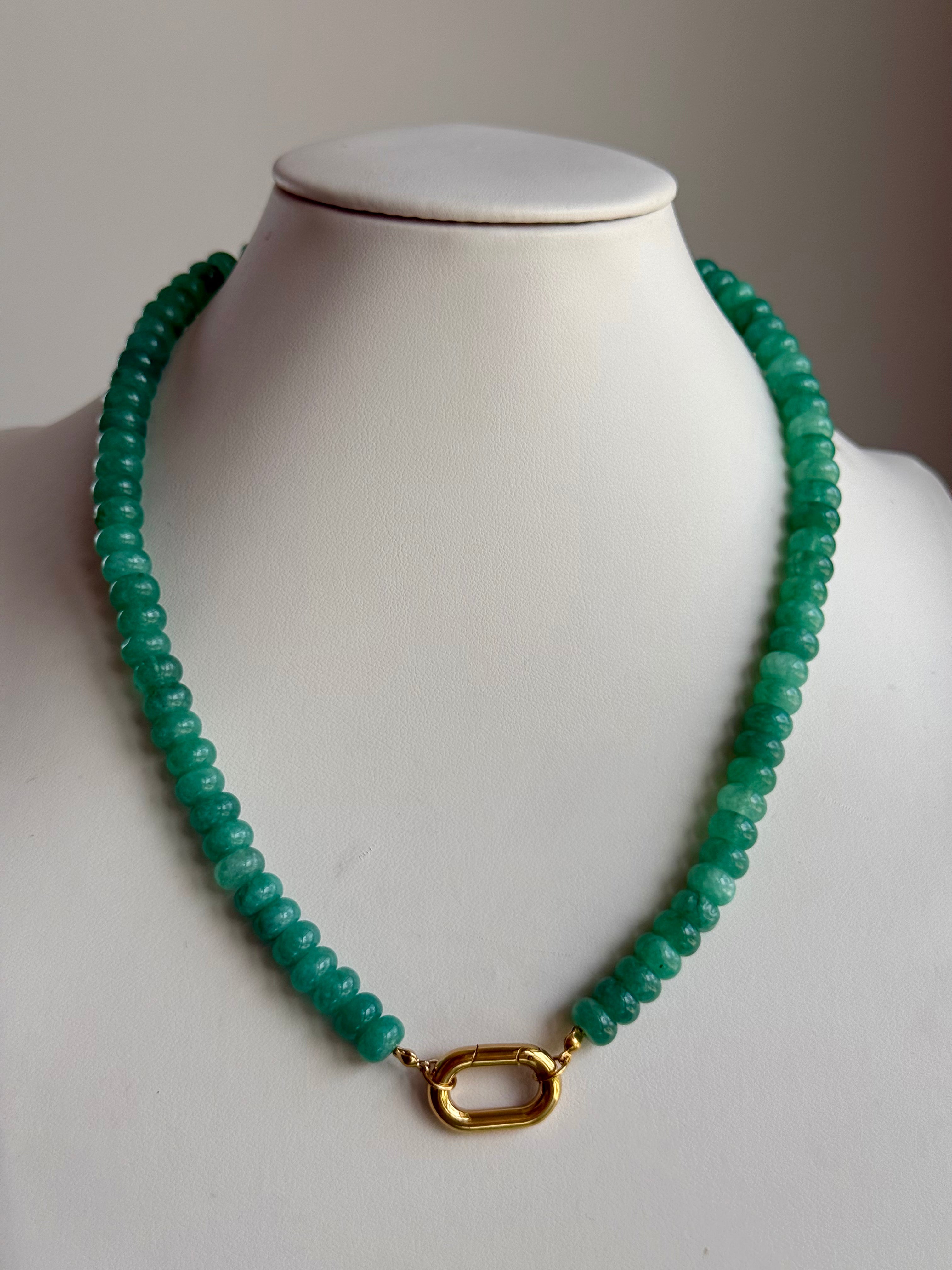 Keepsake Strand Necklace in emerald green beads with a gold-tone clasp on a white display bust