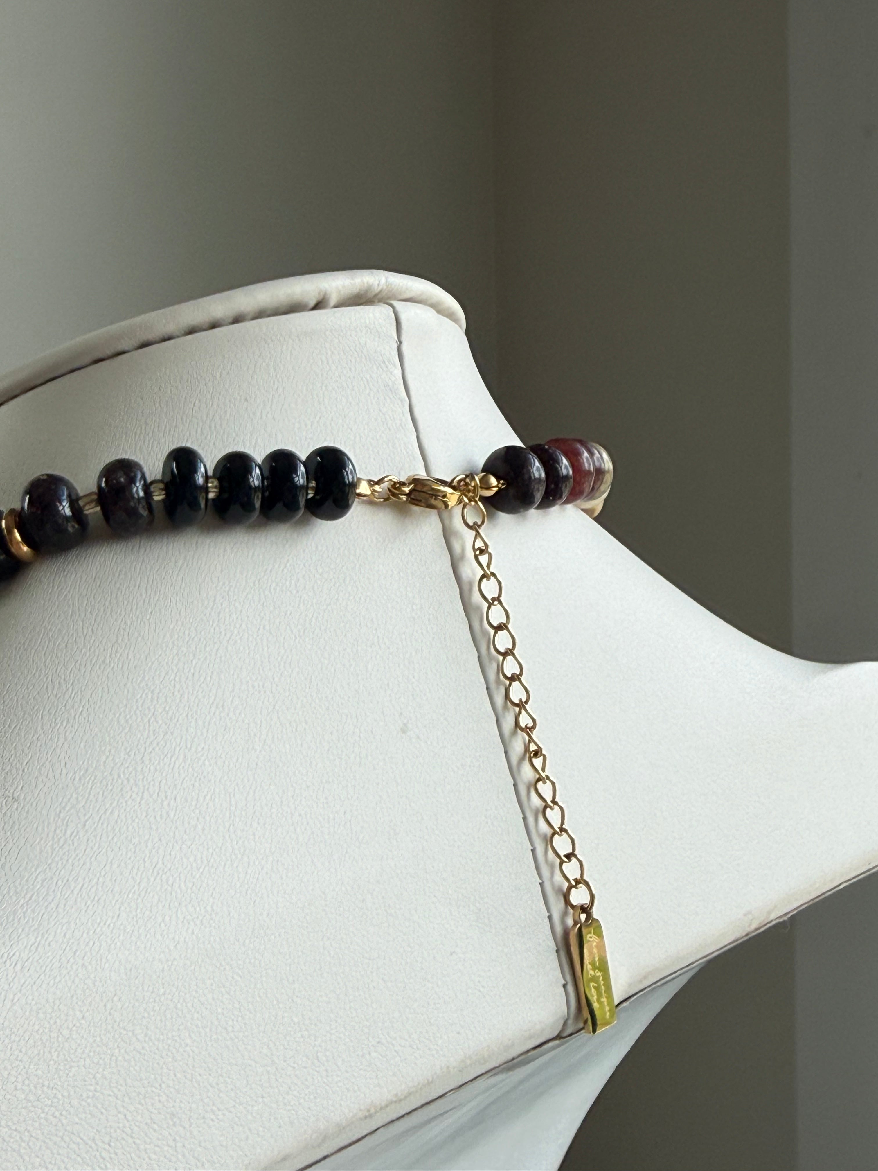 Keepsake Strand Necklace Harvest Moon; dark beads with gold-tone chain and pendant on a white display
