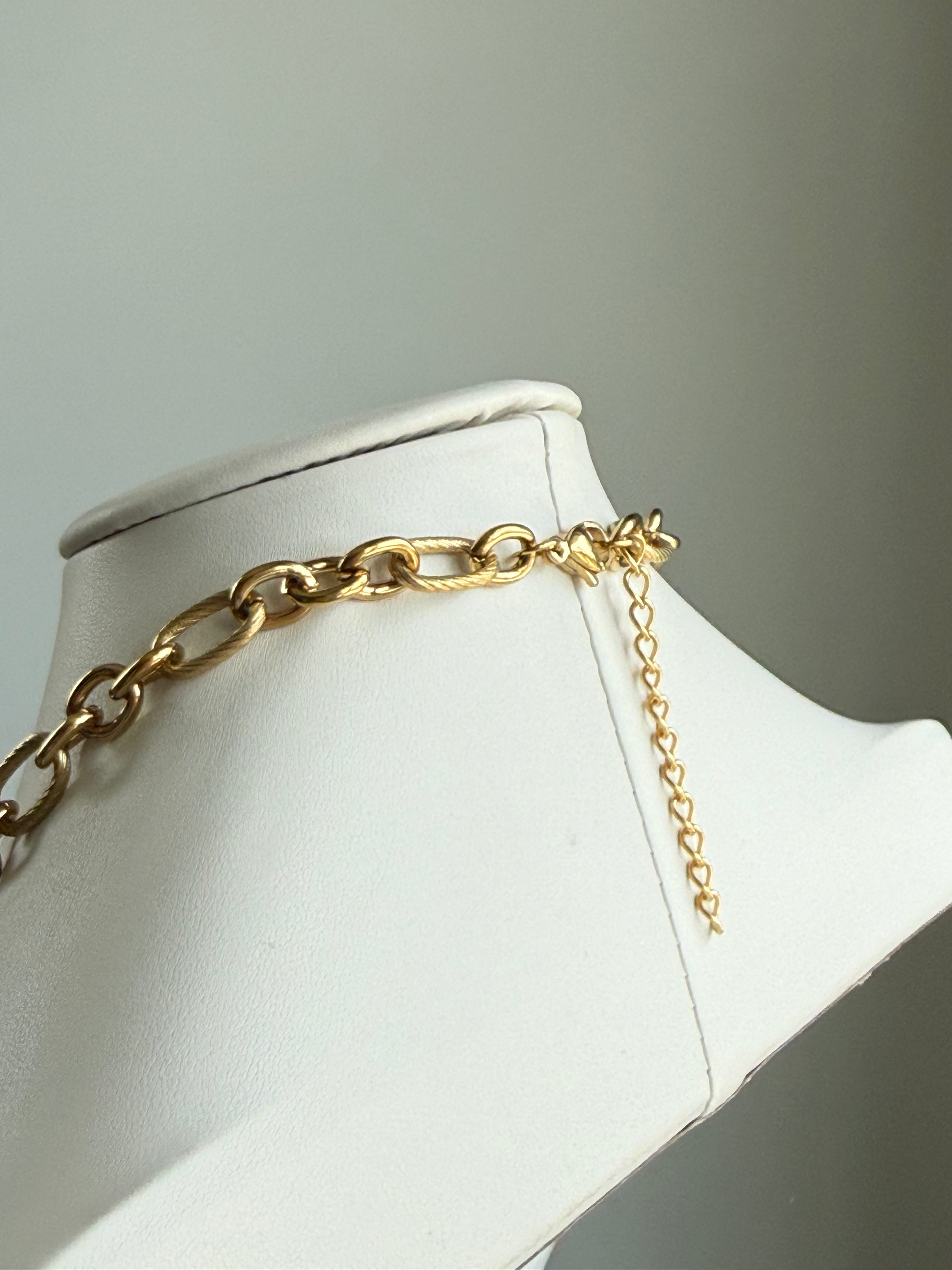 Signature Chain gilded rope necklace in gold tone draped on a white display bust