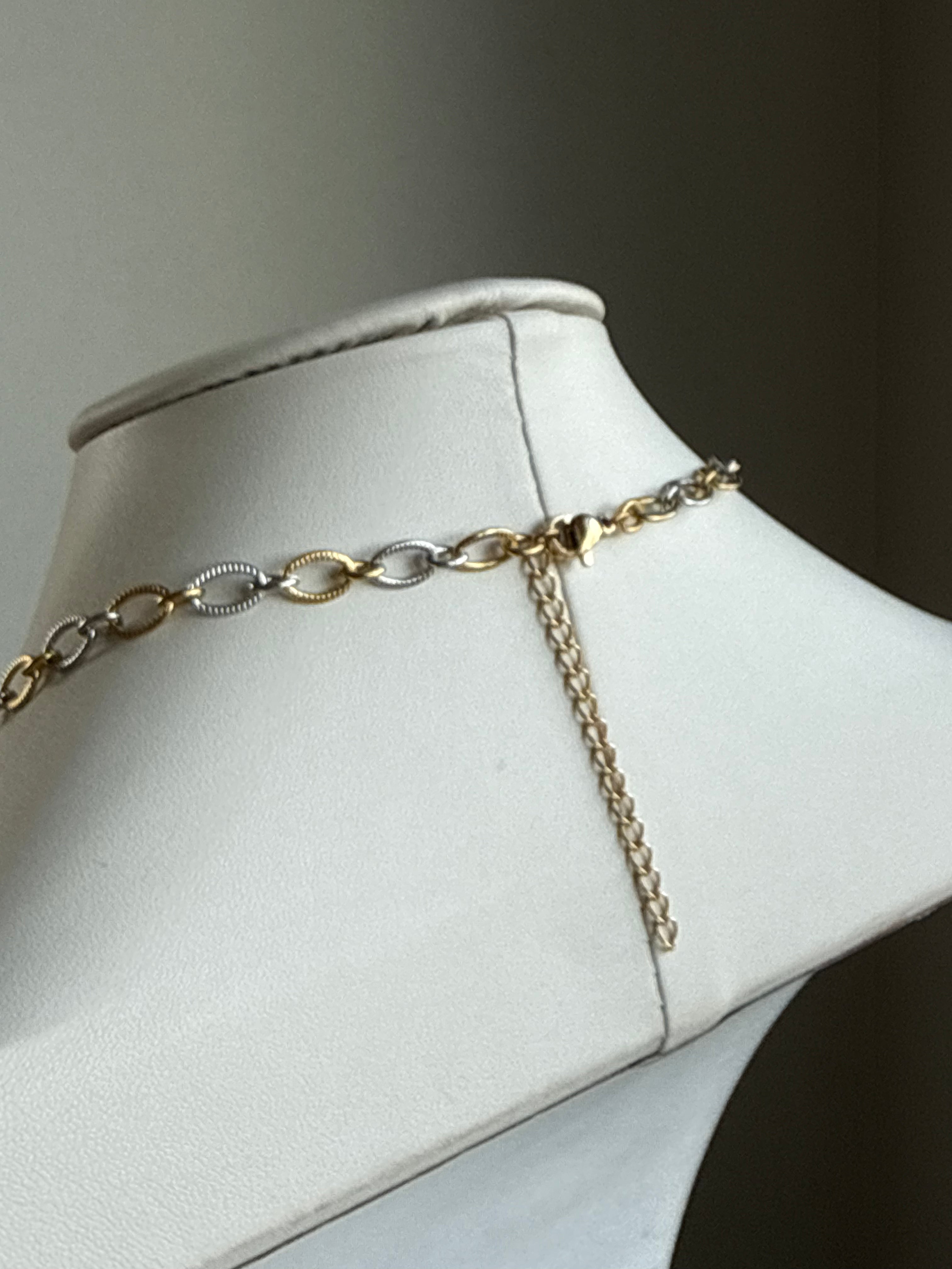 Signature Chain / Mixed Metal Muse necklace with gold and silver link chains on display