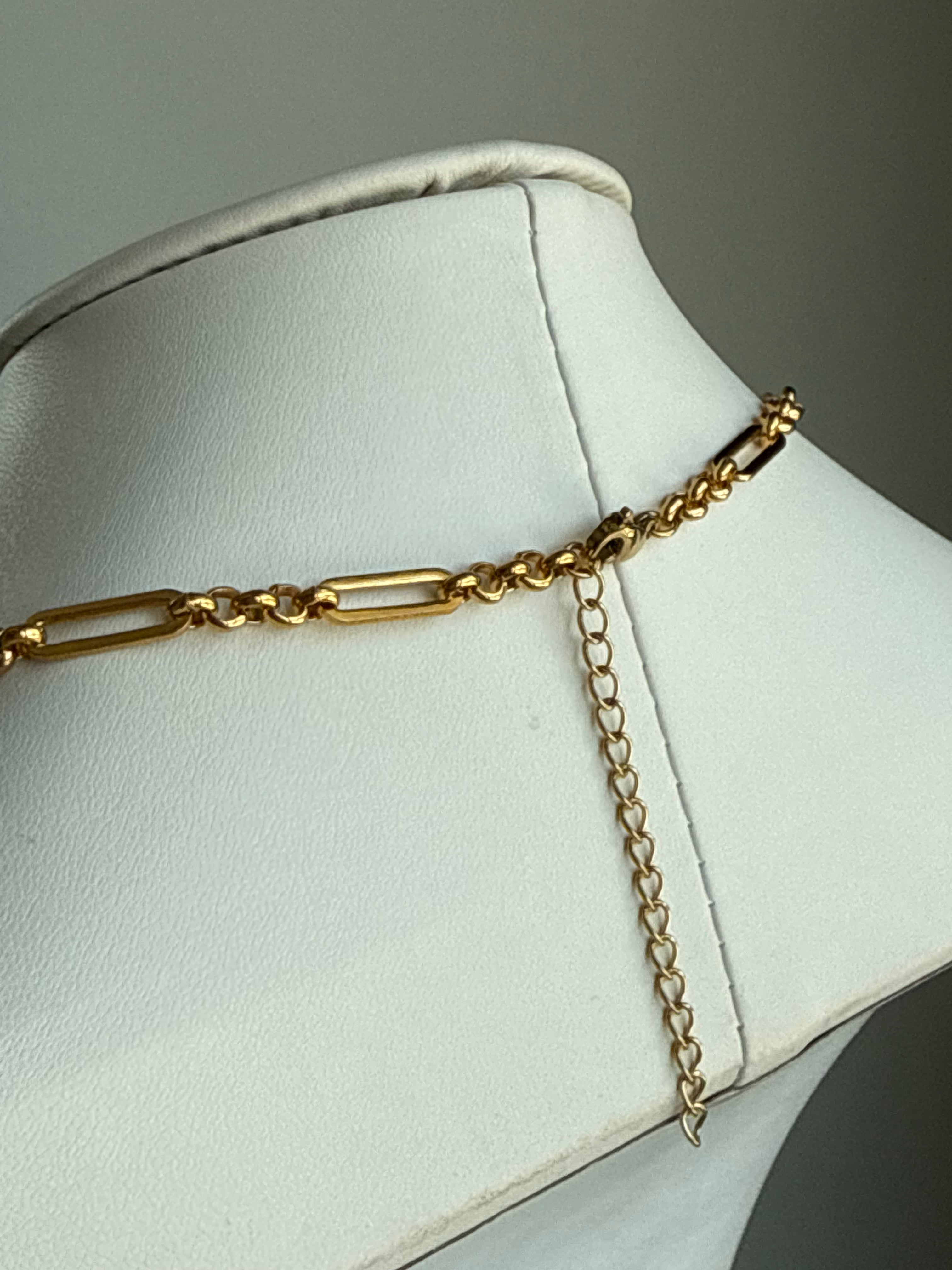 Signature Chain necklace, thin modern keepsake in gold-tone metal on a white display.