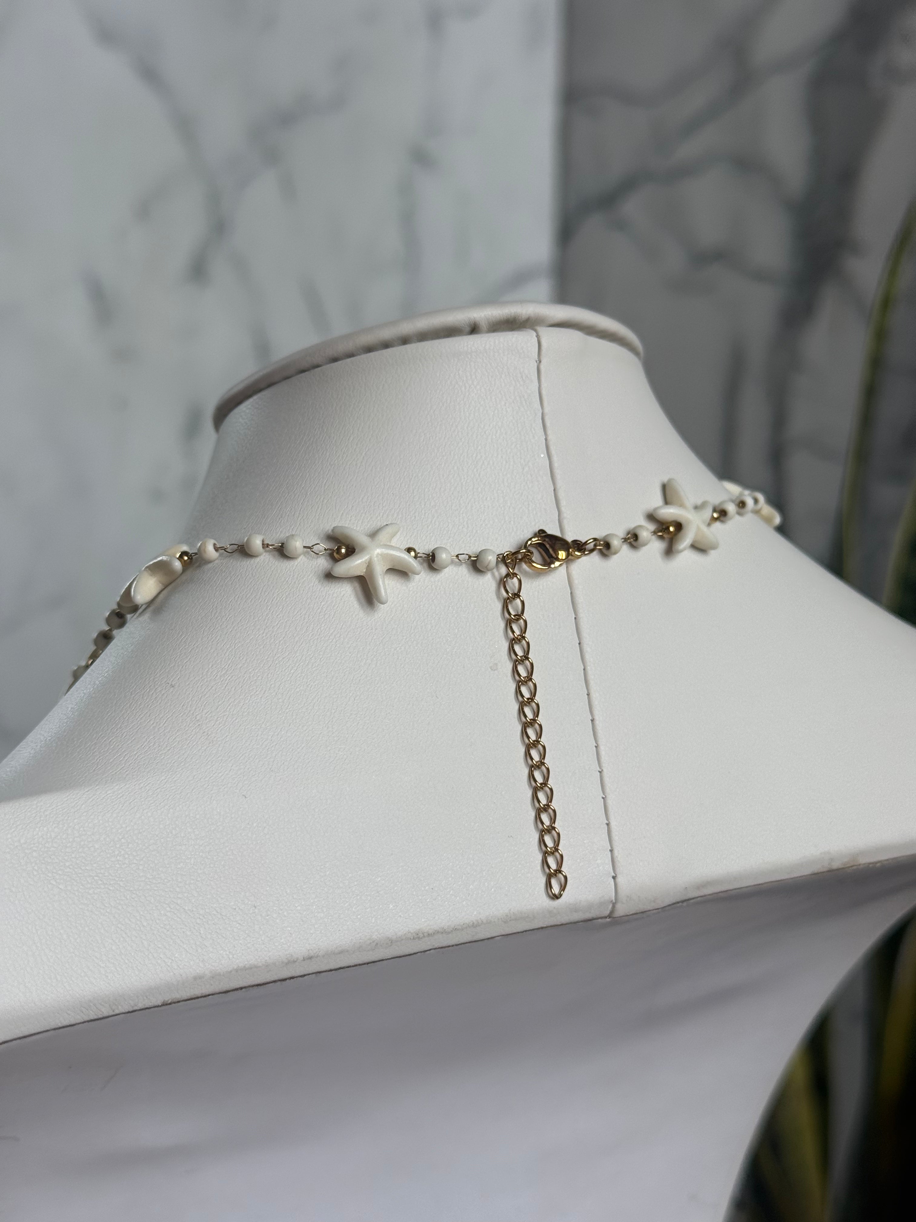 Signature Chain / Driftwood necklace with ivory beads and starfish accents on a gold-tone chain