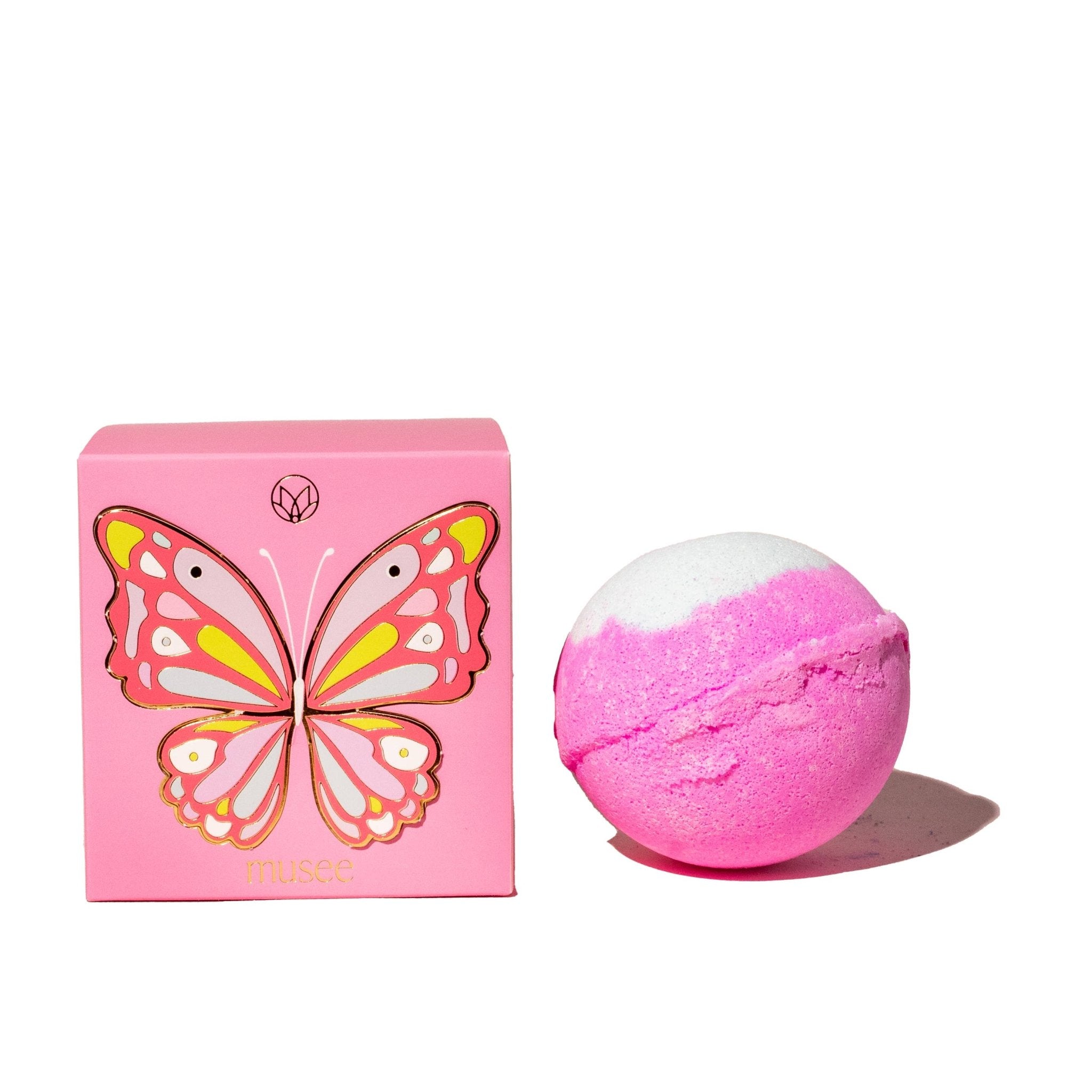 Two pink butterfly bath balms beside a pink Musee box.
