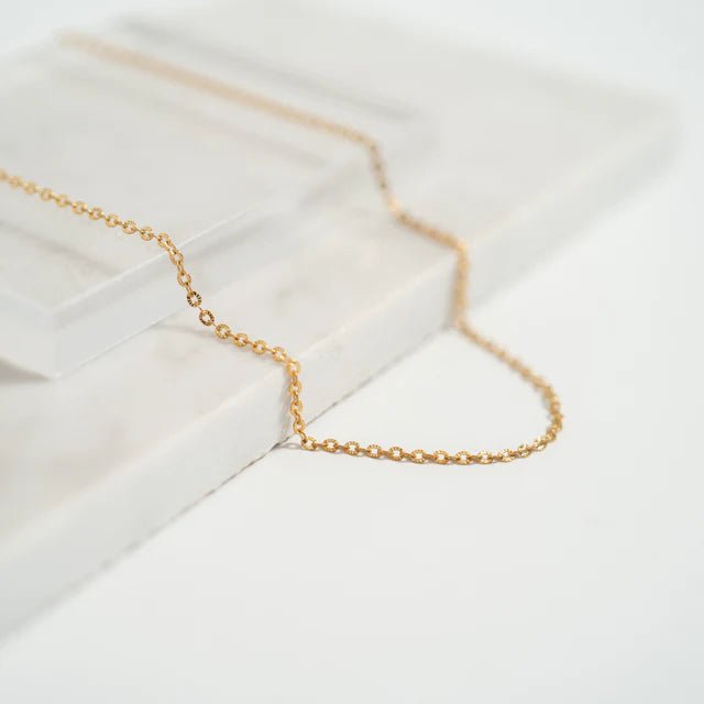 Crimped Oval Link Chain Necklace in gold-tone, delicate chain on white display