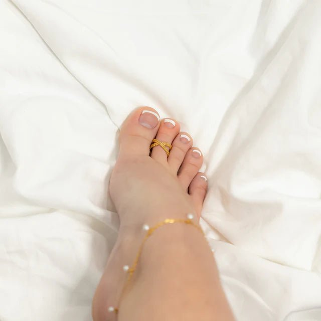 Cross Over Toe Ring by From Juniper With Love; gold-tone crossover band worn on toe