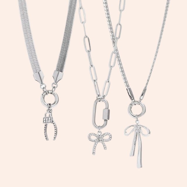 Three silver Herringbone Charm Holder Necklaces by From Juniper With Love, each with a distinct charm pendant