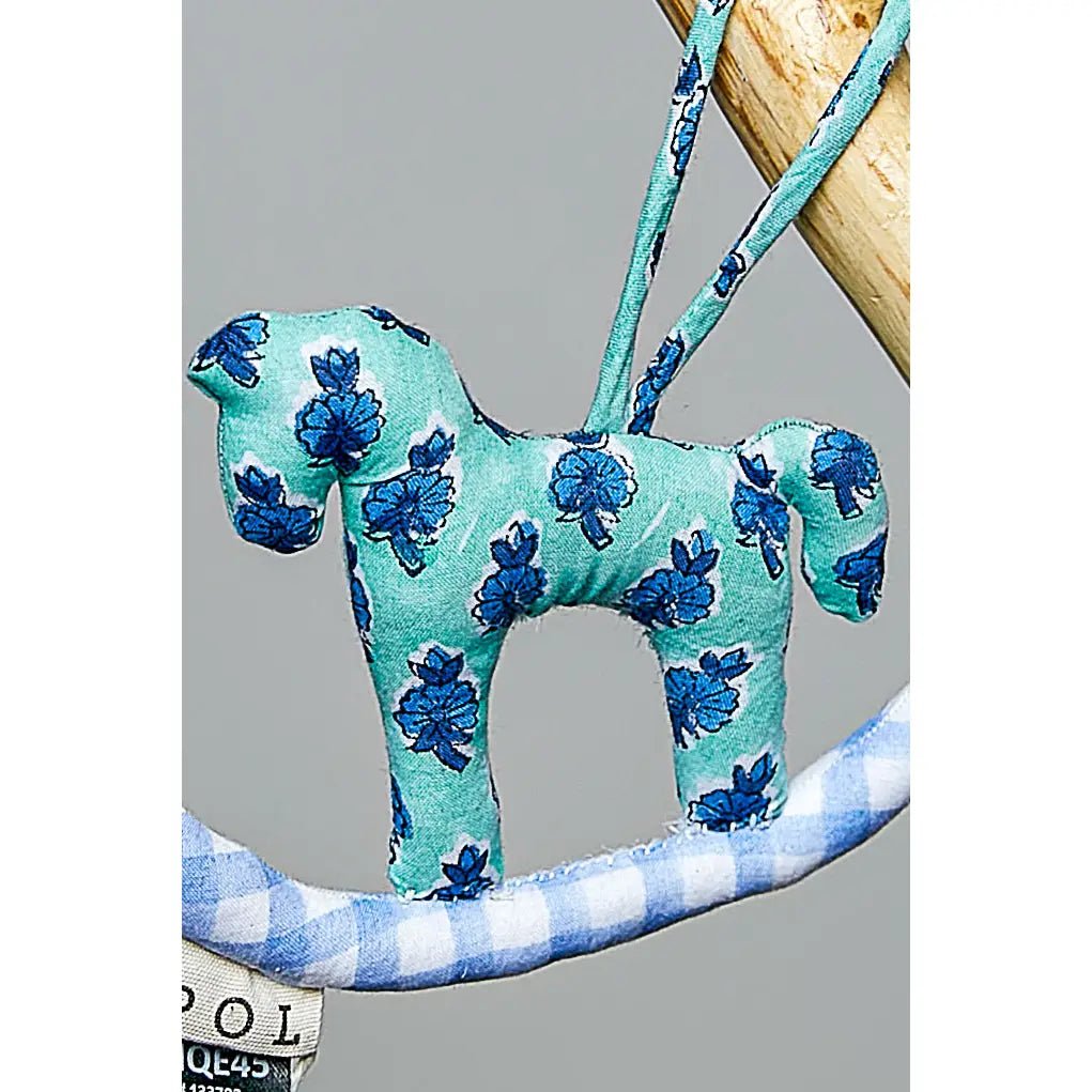 Plush rocking horse bag charm by POL in teal fabric with blue floral pattern keychain accessory.