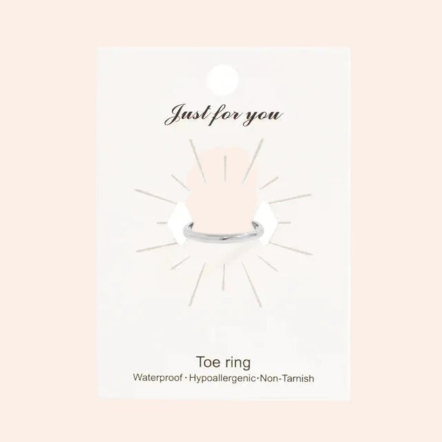 Toe ring by From Juniper With Love in silver metal on a white display card.
